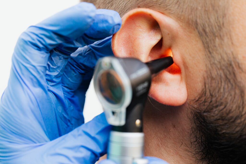 Ear Examination using otoscope before earwax removal with syringing